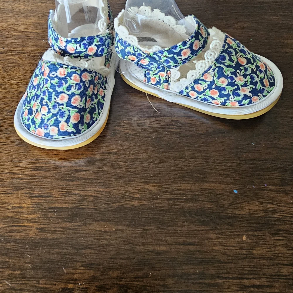 3 pairs of baby/girl shoes—soft, floral, and glittery—in various styles.